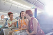 © Caiaimage/Agnieszka Olek/Caia Image - Young women friends drinking champagne in first class on airplane