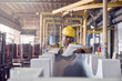 © Caiaimage/Agnieszka Olek/Caia Image - Steelworker with clipboard in steel mill