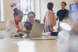 © Sam Edwards/Caia Image - Female architects using laptop in conference room meeting