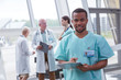 © Rafal Rodzoch/Caia Image - Portrait confident male nurse with clipboard in hospital lobby