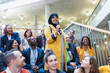 © Sam Edwards/Caia Image - Smiling woman in hijab speaking with microphone in conference audience