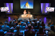 © Tom Merton/Caia Image - Audience watching speakers on stage