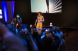 © Martin Barraud/Caia Image - Audience with camera phones photographing speaker on stage