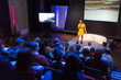 © Martin Barraud/Caia Image - Female speaker on stage talking to audience