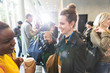 © TomMerton/Caia Image - Smiling businesswomen talking and drinking coffee at conference