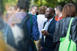 © Martin Barraud/Caia Image - Businessman with coffee talking to colleagues at conference
