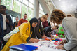 © Sam Edwards/Caia Image - Businesswoman in hijab arriving, checking in at conference registration table
