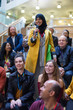 © Martin Barraud/Caia Image - Smiling woman in hijab talking with microphone in conference audience