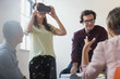 © Sam Edwards/Caia Image - Computer programmers testing virtual reality simulator glasses in open plan office
