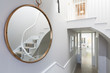 © Charlie Dean/Caia Image - Reflection of foyer staircase in round mirror