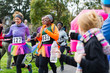 © Sam Edwards/Caia Image - Female runners in tutus running at charity race in park