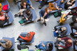 © TomMerton/Caia Image - Overhead view conference audience listening to speaker with microphone