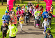 © Chris Ryan/Caia Image - Crowd running at charity run in sunny park