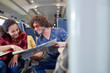 © Agnieszka Olek/Caia Image - Young couple looking at map on passenger train