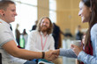 © Martin Barraud/Caia Image - Businesswomen shaking hands at conference