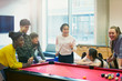 © Rob Daly/Caia Image - Teenagers playing pool in community center