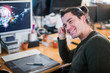 © Chris Ryan/Caia Image - Portrait smiling, confident male graphic designer working at desk
