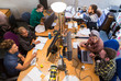© Chris Ryan/Caia Image - Creative business people working, meeting at computers laptop in open plan office