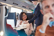 © Agnieszka Olek/Caia Image - Woman credit card using contactless payment, paying attendant on passenger train