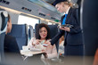 © Agnieszka Olek/Caia Image - Businesswoman smart phone using contactless payment, paying attendant on passenger train