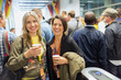 © TomMerton/Caia Image - Portrait smiling, confident women drinking coffee at conference