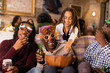 © Sam Edwards/Caia Image - Playful multi-generation family wearing Christmas glasses, enjoying popcorn