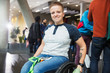 © Sam Edwards/Caia Image - Portrait smiling young woman in wheelchair at conference