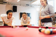 © Sam Edwards/Caia Image - Teenagers playing pool in community center