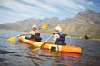 © Trevor Adeline/Caia Image - Active senior couple kayaking in sunny summer lake