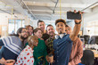 © Chris Ryan/Caia Image - Creative business team taking selfie in office