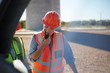 © Trevor Adeline/Caia Image - Female worker using walkie-talkie at power plant