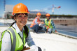 © Trevor Adeline/Caia Image - Portrait smiling, confident female engineer at sunny power plant