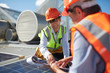 © Trevor Adeline/Caia Image - Engineers with clipboard examining solar panel at sunny power plant