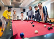 © Rob Daly/Caia Image - Teenagers playing pool in community center