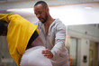 © Sam Edwards/Caia Image - Dance instructor helping teenage girl student stretch in dance class