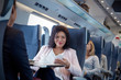 © Rafal Rodzoch/Caia Image - Portrait smiling, confident businesswoman using smart phone on passenger train