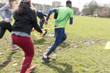 © Sam Edwards/Caia Image - People exercising, doing team building exercise in sunny park
