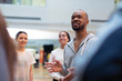 © Sam Edwards/Caia Image - Male instructor leading discussion in dance class studio