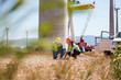 © Trevor Adeline/Caia Image - Engineers reviewing plans at turbine power plant
