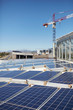 © Trevor Adeline/Caia Image - Solar panels stacked on sunny rooftop