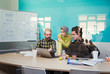 © Robert Daly/Caia Image - Business people working at laptop in conference room meeting