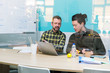 © Robert Daly/Caia Image - Businessmen using laptop in conference room meeting