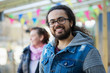 © Chris Ryan/Caia Image - Portrait smiling young man with beard and long hair