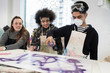© Sam Edwards/Caia Image - Teenagers spray painting in art class