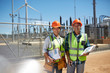 © Trevor Adeline/Caia Image - Portrait smiling, confident engineers with clipboards at power plant