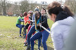 © Sam Edwards/Caia Image - Determined team pulling rope in tug-of-war in park