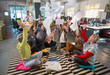 © Chris Ryan/Caia Image - Playful, enthusiastic creative business team throwing paperwork overhead in open plan office