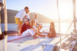 © Trevor Adeline/Caia Image - Friends relaxing on sunny catamaran