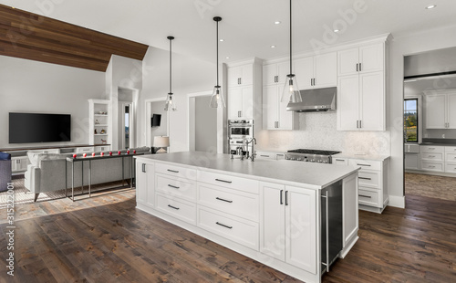 Beautiful kitchen in new luxury home with stainless steel appliances, pendant li Tableau sur Toile