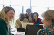 © Martin Barraud/Caia Image - Senior business people working at laptop in conference room meeting